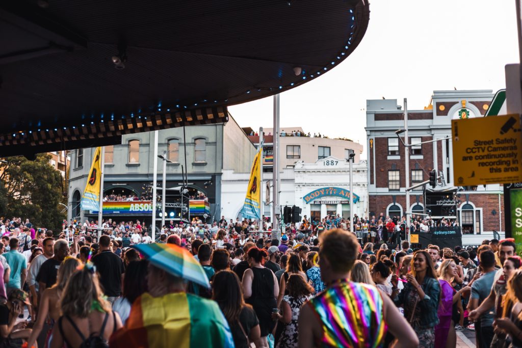 People gathers at a pride event dressed in rainbows