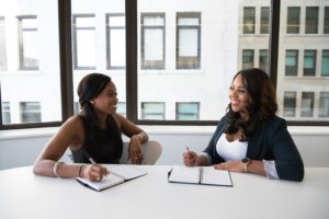 two women discuss business